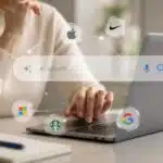 Person using a laptop with an AI search bar surrounded by the logos of well-known global brands